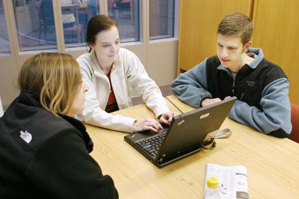 Working on a group lab report for their natural resources measurements class, juniors in natural resourses Liz Montgomery, Lee Anna Young and John Atkinson use the Natural Resources Library in Jordan Hall. "I'd rather come here than D.H. Hill because all the books and resources we need are in one spot, and it would take forever to find them over there," Montgomery said. "We have a lot of group projects, and this library has more space for group work than the main library," Young said. Photo by P