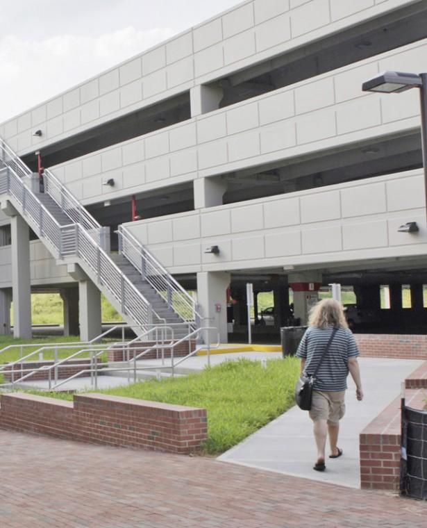 A student walks to the Partners Way parking deck addition on Centennial Campus Tuesday. The addition was completed this summer. The lot gained two stories of additional permit parking and two stories of self-pay parking. Photo by Dreier Carr