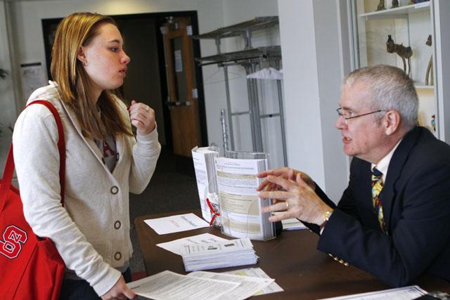 Victoria Johanningsmeier, sophomore in psychology, listens to Dr. Robert Kochersberger talk about the process of getting a passport on the 2nd floor of Talley Student Center. The Passport Fair has been held at N.C. State for the past six years and always occurs during International Education Week, which is the third week in November every year. &#8220;I&#8217;m looking to study abroad in Italy over the summer,&#8221; Johanningsmeier said. Photo by Nick Toptine