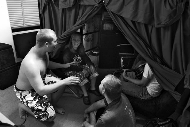 In Suite 304 in Sullivan Hall, Kelly Cox, a freshman in zoology, and Taylor Buchanan, a freshman in chemical engineering, look on as Ryan Collinsworth, a freshman in psychology and spanish, sings and Josh Knight, a freshman in nuclear engineering, plays "Cinderella" on the guitar Wednesday night before a Chemistry Lab. They were all chilling underneath Buchanan's and Collinsworth's lofted beds that they had pushed together to make a king-sized bed. They've also put a chair and a couch, along w