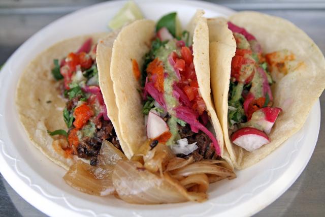 These tacos de lengua, or beef tongue, are some of the most popular types in Mexico. Don Beto EL Poblano garnishes theirs with onion, cilantro, radishes and fresh lime. Photo by Natalie Ross.