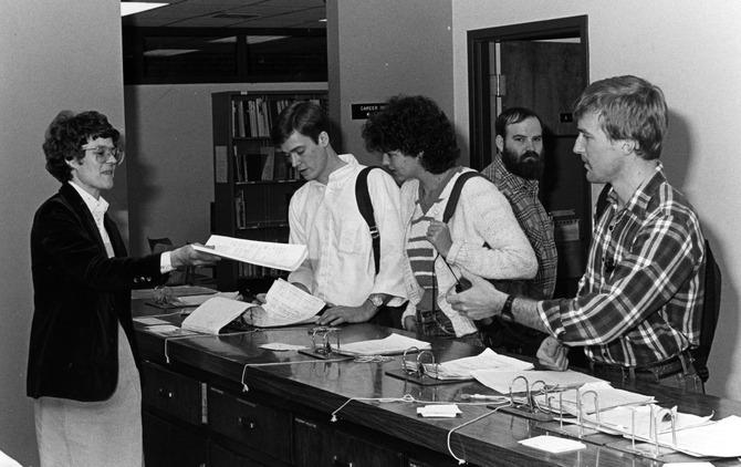 Use your resources. Students receiving information from the career center in 1983.