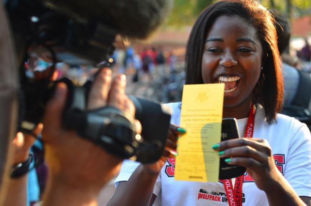 Polymer and color chemistry freshman Courtney Priester holds her ticket to Barack Obama's speech up for a WRAL camera in the Brickyard Sept. 13, 2011. "It means a lot," Priester said. "I get to tell my children about it." Obama's visit to N.C. State will be the first from a sitting president since Ronald Reagan in 1986. Photo by Alex Sanchez.