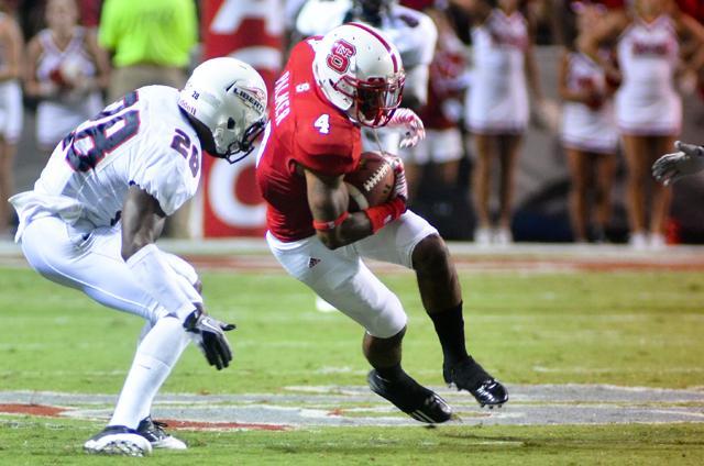 Redshirt junior Tobais Palmer braces for a hit from Liberty University's Lee KaJuan on the field of Carter Finley Sept. 3, 2011. Palmer had 3 receptions for 46 yards in the 43-21 Wolfpack victory. Photo by Alex Sanchez.