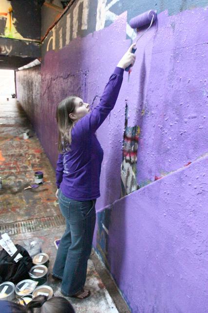 Jenny Lomelino, a Gradauate Student in English Education, paints the free expressional tunnel in order to raise awareness against Domestic Violence, Monday October 2rd, 2011. Photo by Thomas Obarowski