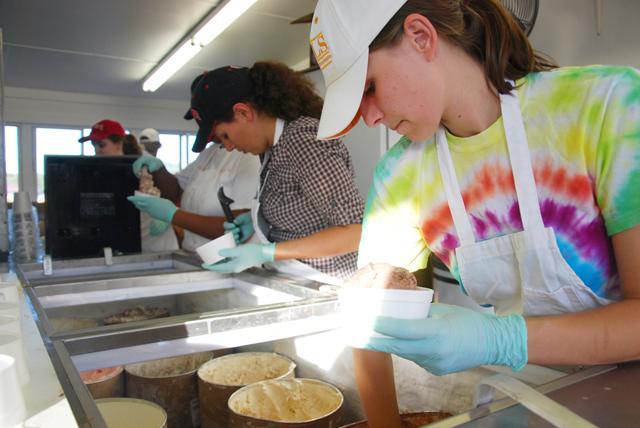 Graduate student in food science, Amanda Draut, scoops a cup of strawberry ice cream on Oct. 15th, 2011. Photo by Ben Tran