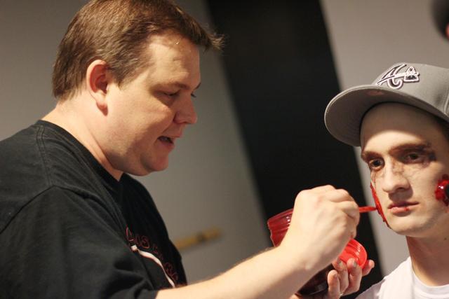 Alan Watkins demonstrates how to apply zombie makeup to volunteer Cory Smith, senior in english, on Tuesday October 18 2011. Watkins, who has been involved in the production of several films, explained that he enjoys horror because people watch it for not just the plot, but also the special effects. Photo by Tyler Andrews