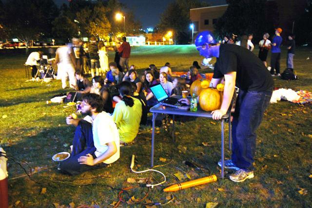 Steve Rau, a senior in mechanical engineering, helps set up the equipment for a halloween event hosted by NCSU's Disney Movie Club on Thursday, Oct. 27. The night began with food, games and costumes, and later centered around members of the club enjoying and singing along with the Nightmare Before Christmas. Photo by Jade Loring.