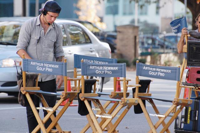A crew worker sets up chairs on the set of "Arthur Newman, Golf Pro," a movie currently being filmed in Raleigh. The movie's stars Colin Firth, Emily Blunt, and Anne Heche were filming throughout downtown Raleigh all day on Wednesday, Nov. 9, 2011. "Arthur Newman, Golf Pro" is directed by Dante Ariola and is slated to release in 2013. Photo by Megan Farrell
