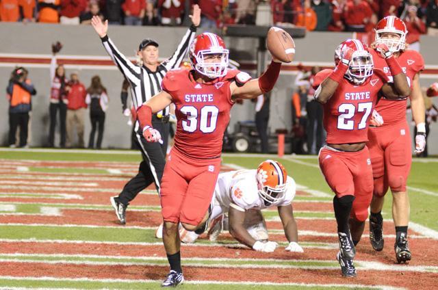 Junior safety Brandan Bishop celebrates after intercepting for a touchback during the third quarter against Clemson in Carter-Finley Stadium on Saturday, Nov. 19. The Wolfpack defeated the No. 7 ranked Tigers 37-13. Photo by John Joyner.