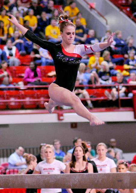 Alex Williams competes on beam Friday, February 25 at Reynolds Coliseum. Williams score of 9.8 contributed to the overall beam score of 49.250, which ties for the 10th highest score on beam in school history. The team fended the night with a team score of 196.675, which is tied for the sixth highest score in school history. Photo by Nicole Moering.