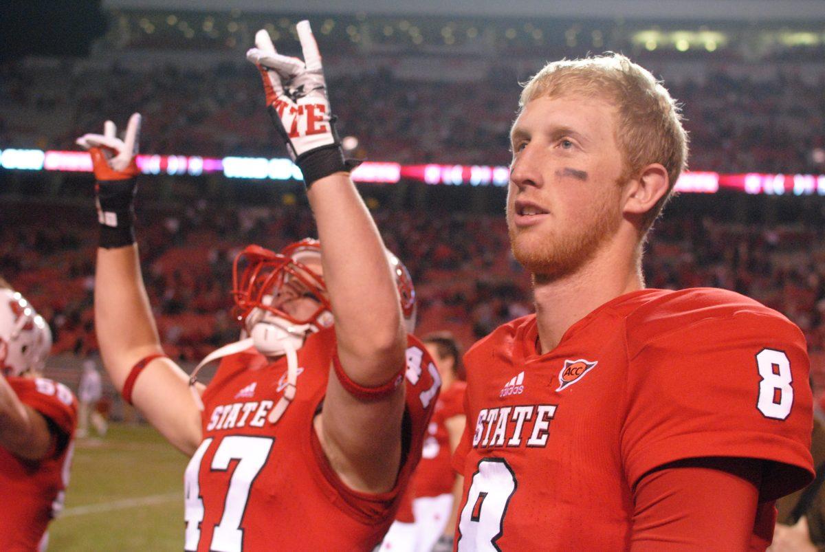 Redshirt graduate student quarterback Mike Glennon and redshirt sophomore fullback Tyler Purvis walk toward the student section after a 37-6 win over Wake Forest at Carter-Finley Stadium. Glennon had 258 total yards in the Wolfpack's win Saturday, November 10, 2012. Photo by Ryan Parry.