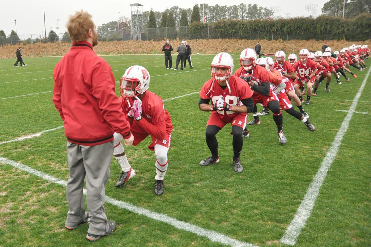 The offense warms up before spring practice at the Dail Football Practice Complex Tuesday, March 19, 2013. Photo by John Joyner.