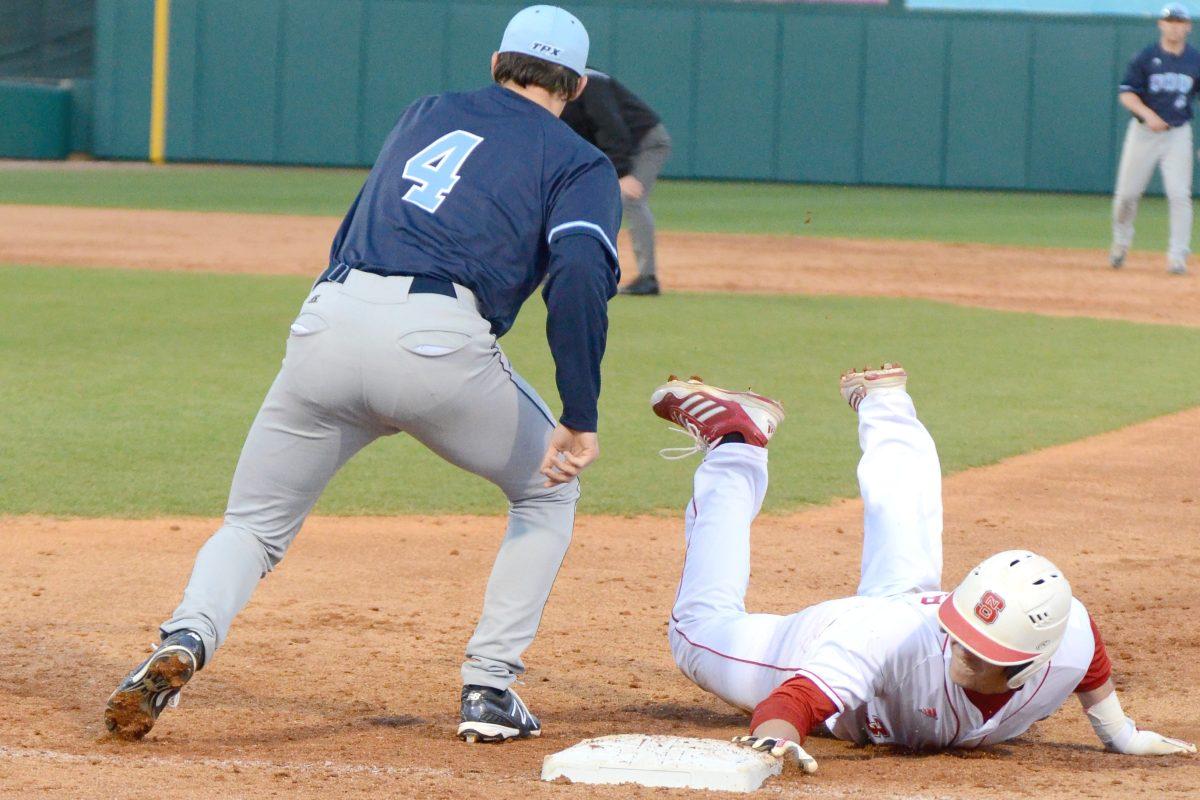 Sophomore outfielder Jake Fincher dives to first base after leading off during the game against Old Dominion on Doak Field Wednesday, Mar. 13, 2013. The Wolfpack defeated the Monarchs, 5-0. Photo by John Joyner.