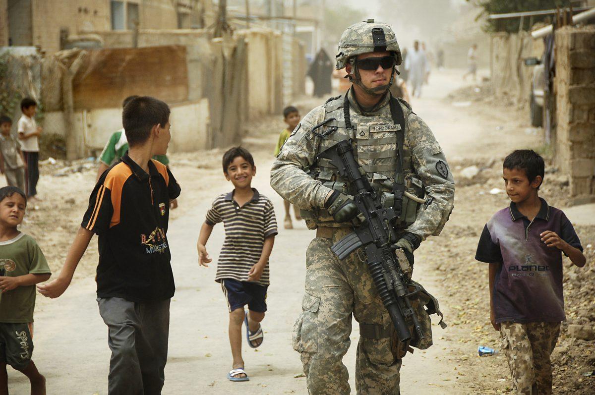 Iraqi children gather around as U.S. Army Pfc. Shane Bordonado patrols the streets of Al Asiriyah, Iraq, on Aug. 4, 2008. Bordonado is assigned to 2nd Squadron, 14th Cavalry Regiment, 25th Infantry Division. DoD photo by Spc. Daniel Herrera, U.S. Army.&#160;