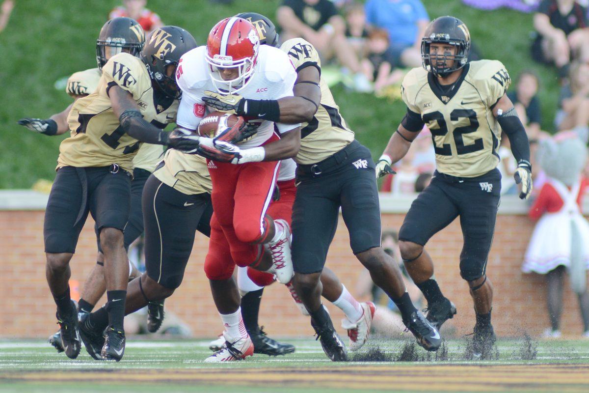 Freshman wide receiver Johnathan Alston is tackled Sat. Oct. 6, 2013 at BB&amp;T Field against Wake Forest. The Demon Deacons defeated the Wolfpack 28-13.