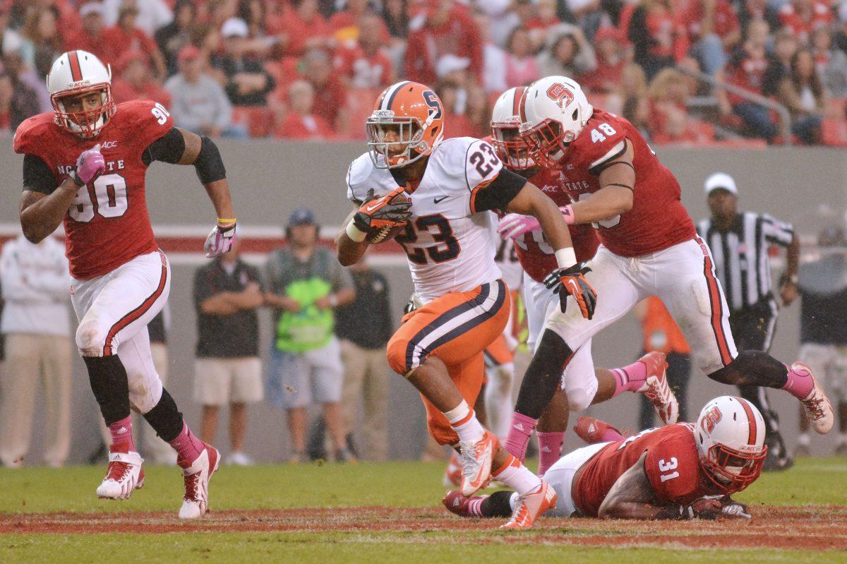 Syracuse senior running back Prince-Tyson Gulley runs the ball down the field after senior linebacker D.J. Green missed a tackle during the football game against new ACC member Syracuse in Carter-Finley Stadium Saturday, Oct. 11, 2013. The Orange defeated the Wolfpack 24-10, dropping N.C. State to 0-3 in conference play. Photo by John Joyner.