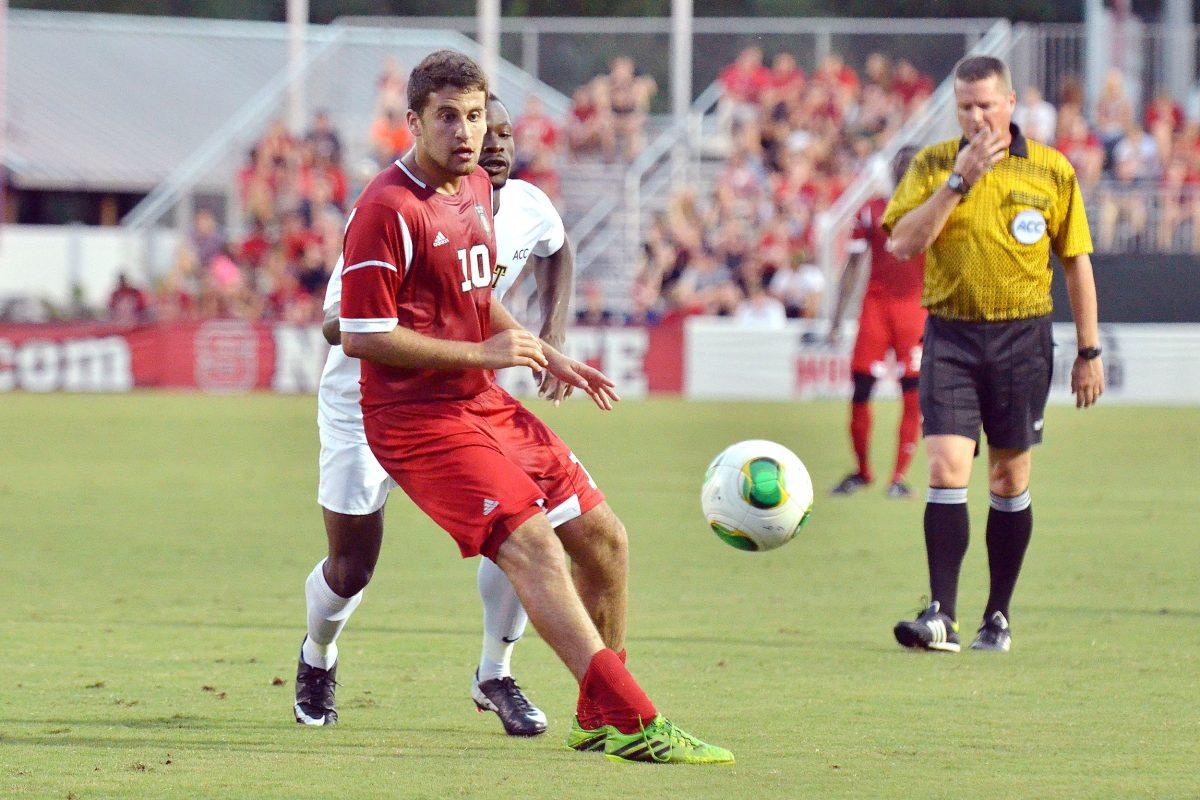 Senior midfielder Nazmi Albadawi passes the ball during the conference opening soccer match against new ACC member Pittsburgh at Dail Soccer Field Friday, Sept. 6, 2013. The Wolfpack defeated the Panthers 1-0 in overtime. Photo by John Joyner.