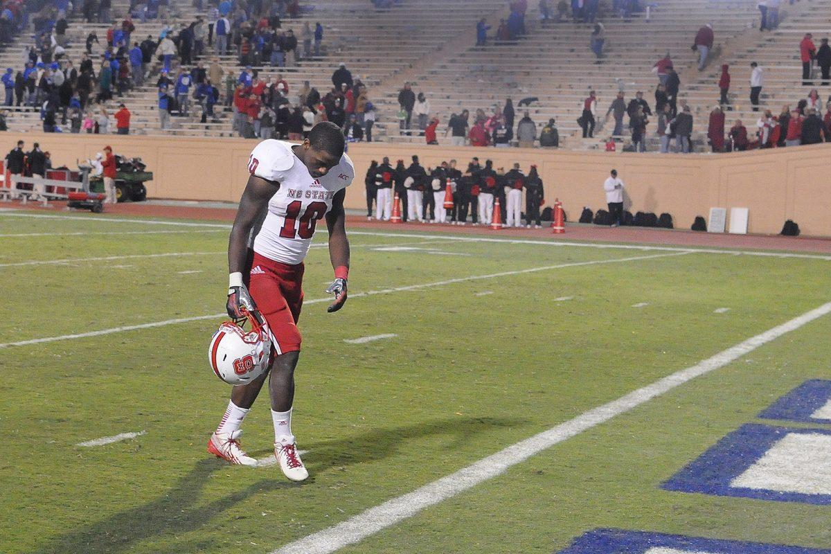 Sophomore running back Shadrach Thornton walks off the field with his head down after the end of the Duke game Saturday, Nov. 9, 2013. Thornton had 103 rushing yards in the Wolfpack's 38-20 loss to the Blue Devils at Wallace Wade Stadium. Photo by Ryan Parry.