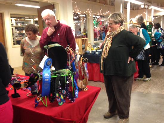 Attendees of the annual Craft Center Holiday Fair browse selections of Raleigh-based art.
