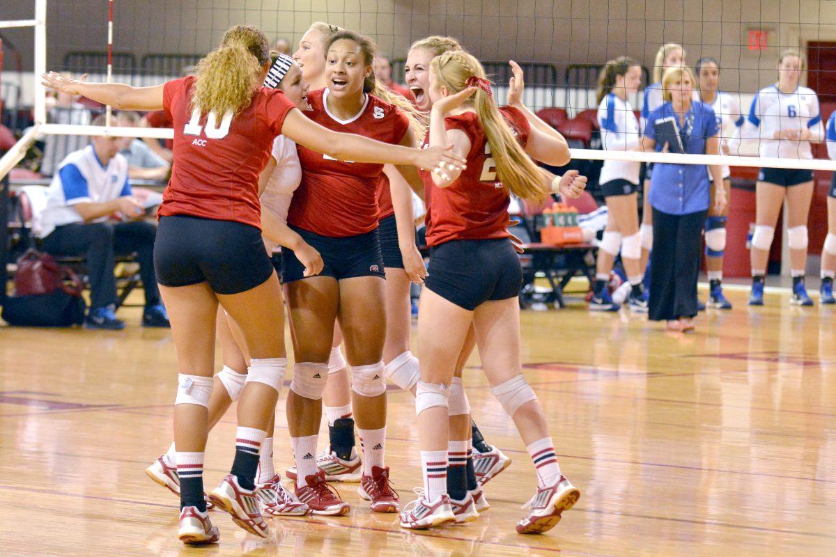 The women's volleyball team celebrates winning a point during the volleyball match against Duke in Reynolds Coliseum on Oct. 13. The Wolfpack beat the Blue Devils, 3-1.
