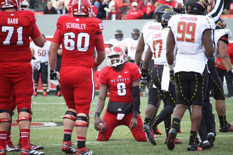 Senior quarterback Brandon Mitchell reacts after failing to reach the first down marker on a scramble during NCSU's 41-21 loss to Maryland at Carter-Finley Stadium Saturday, Nov. 30, 2013. NCSU dropped its last eight games to fall to 3-9 on the season in Dave Doeren's first year as head coach. Photo by Cole J. Stith.