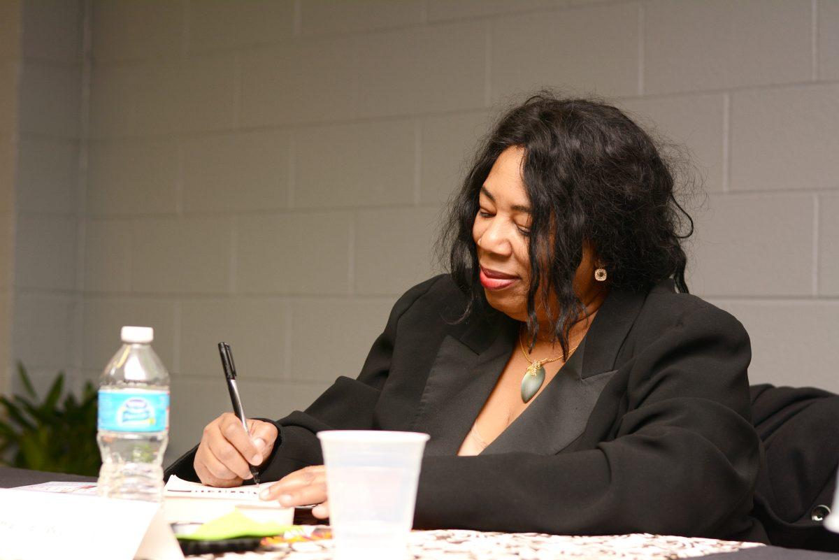 Harriet Washington, winner of the National Book Critics Circle Award and author of the Medical Apartheid &#160;and Deadly Monopolies signs books Feb. 6, 2014 in the Washington Sankofa Room in Witherspoon. Washington spoke on the effect corporations have in the medical field. Photo by Chris Rupert