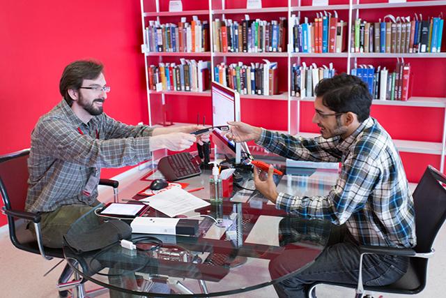 Ph.D. student Arpan Chakraborty receives a Google Glass to try out. Students will soon be able to check out Google Glass at N.C. State libraries along with the other electronic devices that they currently offer. Photo contributed by David Hiscoe.