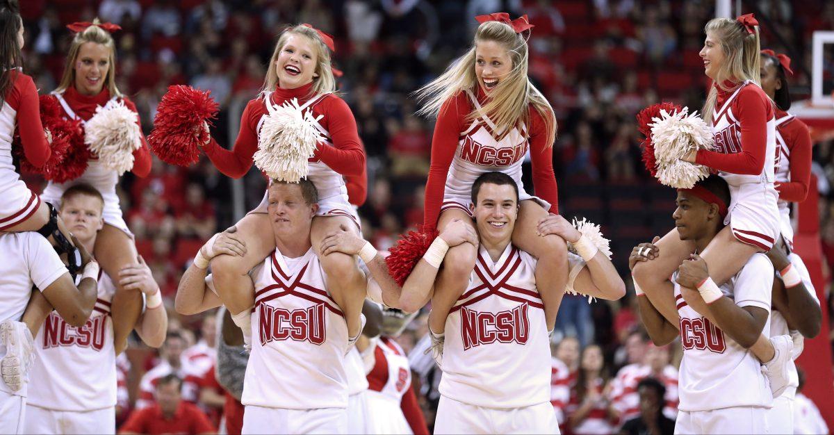 N.C. State cheerleaders take part in a cheer with the pep band during a time out in the second half of the season opening game between N.C. State and Appalachian State University in PNC Arena Friday, Nov. 8, 2013. The Wolfpack defeated the Mountaineers 98-77. Photo by John Joyner.