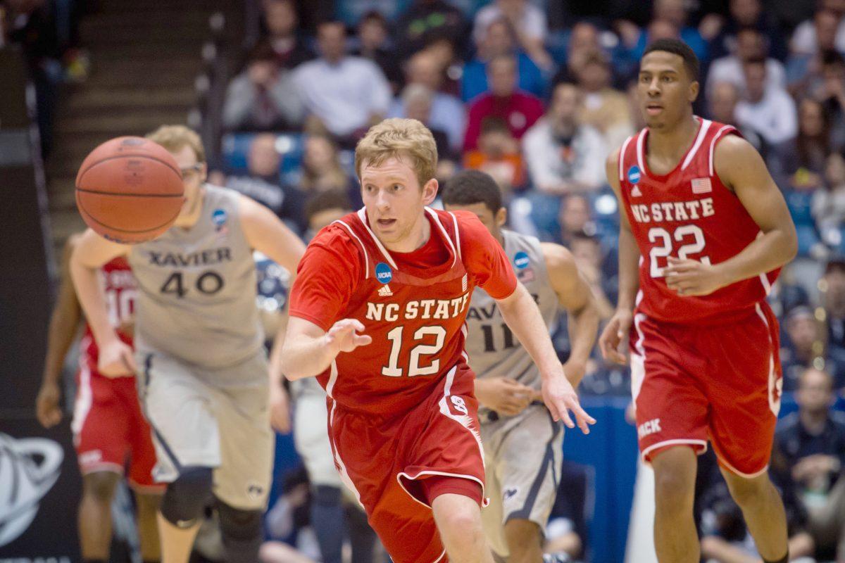 Sophomore point guard Tyler Lewis chases the ball in front of junior guard Ralston Turner, Xavier junior center Matt Stainbrook and Xavier junior guard Dee Davis during the Wolfpack&#8217;s 74-59 win over the Musketeers in the first round of the NCAA Tournament Tuesday in Dayton, Ohio.