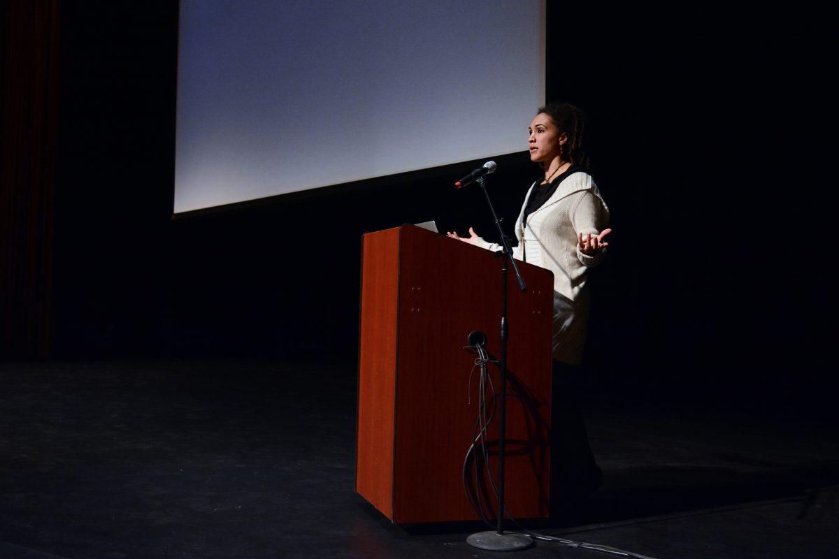 Ch&#233;rie Rivers Ndaliko, assistant professor in the Music Department at the University of North Carolina Chapel Hill, explains what the Congo is actually like. She showed several music videos from the Congo on an album called "Art from the Front Line". Ch&#233;rie said that "If you are anything like me, you would rather hear music than listen to a lecture" in Titmus Theatre Friday, Feb 28, 2014. Photo by Joseph Phillips