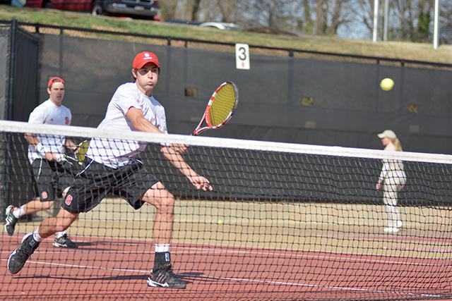 Junior Robbie Mudge smashes a ball over the net during his and teammate Ian Dempster's doubles match with Boston College's Matt Wagner and Aiden McNulty at the J.W. Isenhour Tennis Complex Friday April 4, 2014. The duo, along with teammate Austin Powell, represented NCSU in the NCAA Division I Men's Individual Championships this past week in Athens, GA.. Photo by Caide Wooten.