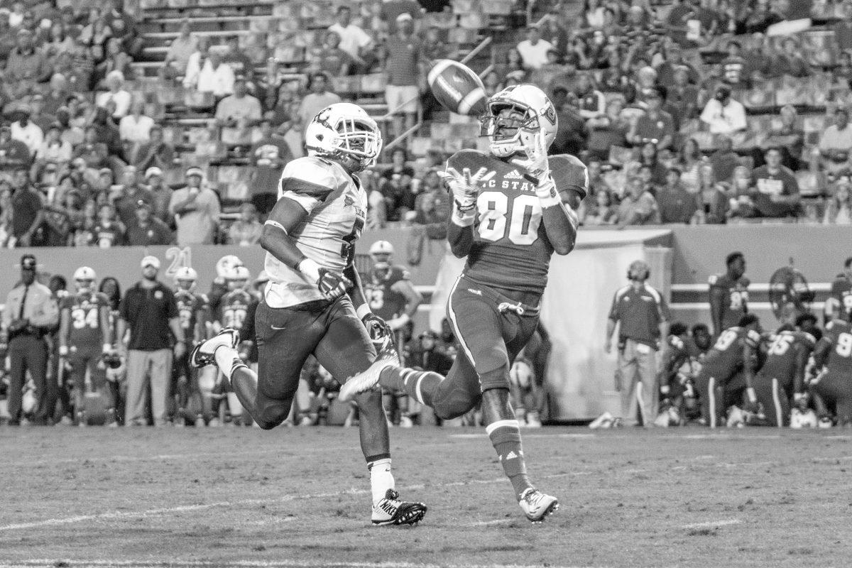 Jacoby Brissett throws a 65 yard touchdown pass to Bryan Underwood against Presbyterian Saturday, Sept. 20, 2014. The Wolfpack defeated the Blue Hose, 42-0. Photo by Ben Salama