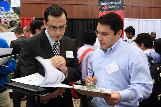 David Varquez, a masters student in aerospace engineering meets with a representative of B/E Aerospace during the Engineering Career Fair in the McKimmon Center on Wednesday. The event marked a record turnout with more than 4,000 students and 373 employers in attendance.