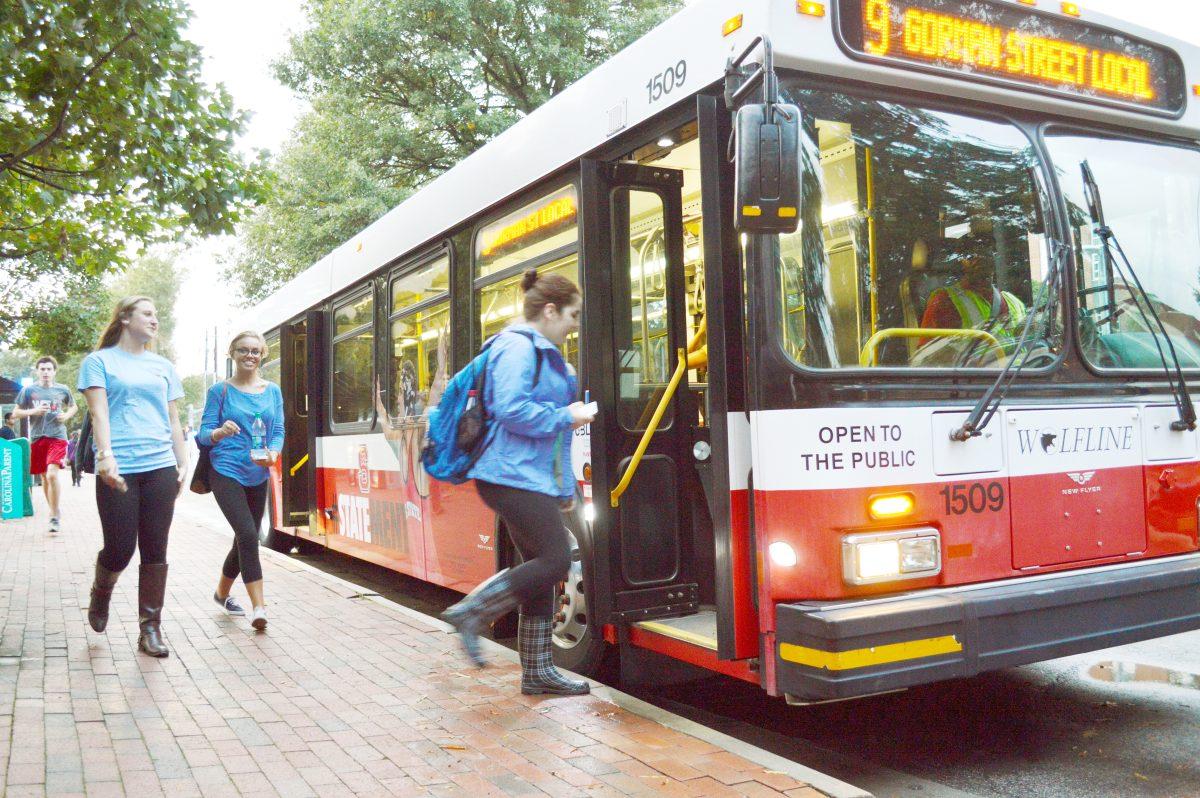 After a long day of classes, students file into one of State's many Wolfline buses near the Wolfline Hub between Hillsborough Street and DH Hill Library. "It's completely absurd," says Courtney Schug, a freshman animal sciences major, "to think that jumping in front of a bus will cause the university to pay you tuition." This particular theory started towards the beginning of the semester and has quickly spread throughout the campus. Photo by Kristin Bradford