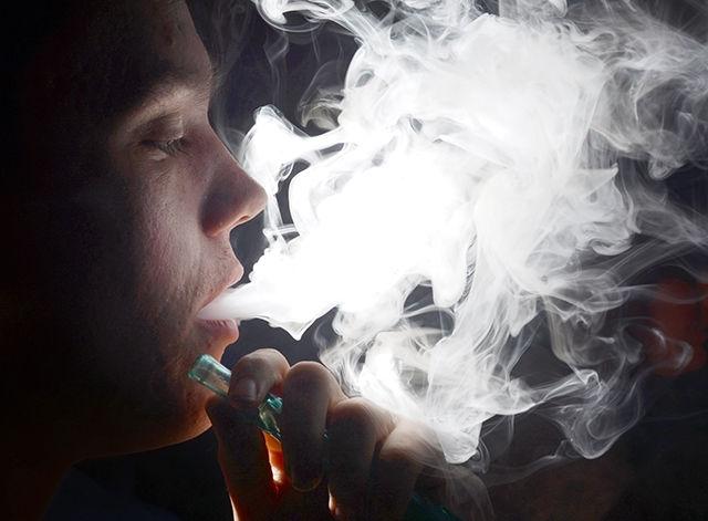 Jay Burke, freshman in business administration, smokes Tuesday evening, Sept. 23, at Nara Lounge on Hillsborough St. Recent surveys have indicated a decrease in overall cigarette use by young adults in NC, but a significant rise in the use of hookahs and e-cigarettes. Photo by Caide Wooten.