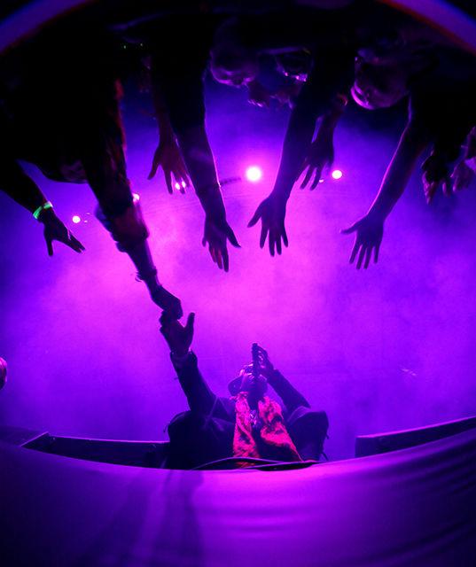 Hip-Hop and R&amp;B artist Jeremih holds hands with a fan Thursday at the annual PackHowl Homecoming Concert in Reynolds Coliseum. The sold-out concert featured a performance by Big Sean with opening acts by Jeremih and T-Pain.