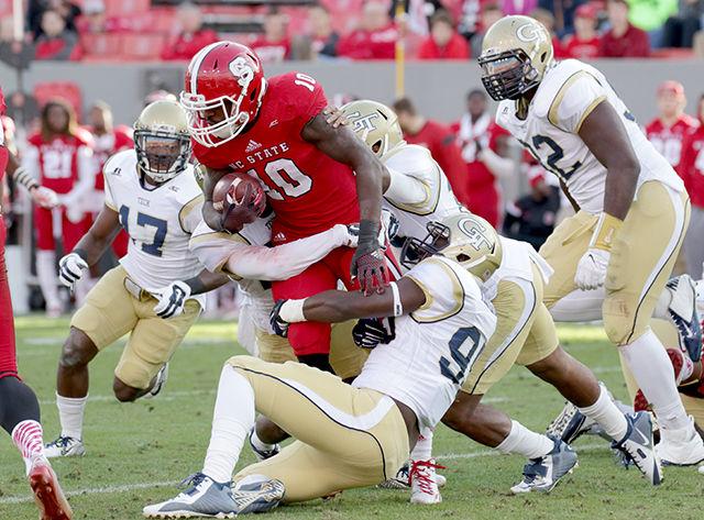 Junior running back Shadrach Thornton gets group tackled by a strong Georgia Tech defense that held the Pack to no rushing touchdowns in the final three quarters of the game. The Wolfpack struggled against Georgia Tech but failed to stop the triple-option attack for the rest of the game, leading to a 23-56 loss on Saturday.