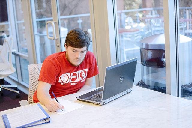 Camden Willeford, a sophomore studying business marketing, takes notes on marketing methods from his laptop in the Silent Reading room in the West Wing of the D.H. Hill Library. When asked about his opinion on the West Wing's closing for renovation next week, "I know it will be for good improvements. I study here a lot but the changes will hopefully make it easier and better for studying" Willeford said. "I can go to the 9th floor bookstacks to study."