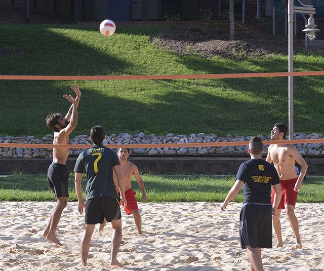 Players of teams Breakfast Is Served and Areia Brazil play sand volleyball at Wolf Village July 15. Areia Brazil won the game. Sand volleyball is one of the three intramural team sports offered by the University Recreation Center during the summer.