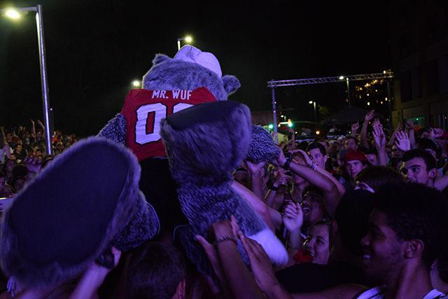 Mr. Wuf crowd surfs as Petey Pablo performs on Hillsborough Street during the Packapalooza festival on Saturday.