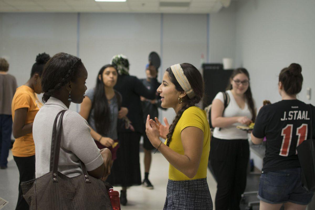 Jessica (Jess) Gallo, a junior double majoring in Social Work and Spanish and Co-President of Diversity and Inclusion adVenture Experience (DIVE) club talks to Cynelsa Broderick, an Americorp Member at the Sustainability office during the organization's interest meeting. The club seeks to address social justice issues by combining outdoor adventures such as hikes, rock climbing and camping with diversity and inclusion activities, both on NC State&#8217;s campus and in a broader context.