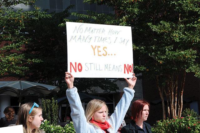 Susan Youngstead, junior in psychology, holds a sign during the SlutWalk on Nov. 2, 2012. "The purpose was to raise awareness of victim-blaming here at N. C. State because this is an issue that many people don't realize affects people all around us," Youngsteadt said.