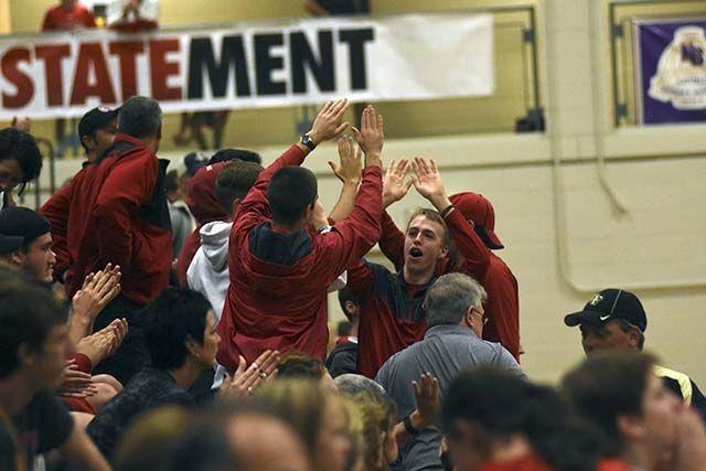 The Wolfpack fans celebrate after winning a point against Wake Forest on October 2nd at Broughton High School. The Wolfpack went on to defeat Wake Forest 3-1.