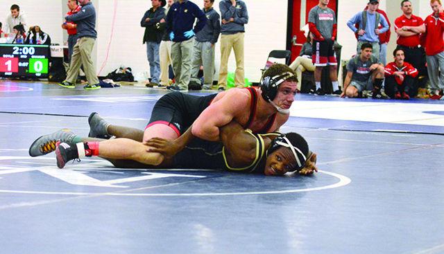 Sophomore 174-pounder Nicholas Hall holds his opponent to the mat. Hall took first place in the Wolfpack Open in his division. The tournament was held all day Sunday, in Carmichael gymnasium.