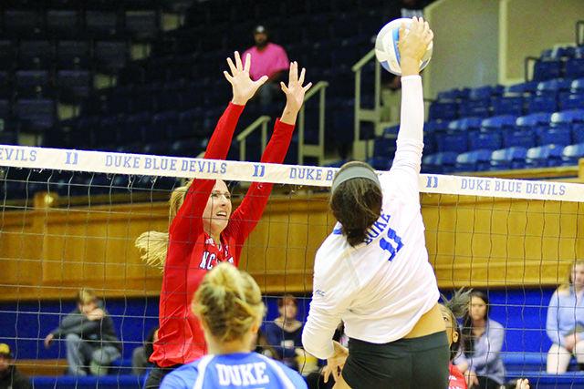 Sophomore MB Kaitlyn Kearney sets to block a spike from a Duke opponent at Cameron Indoor Stadium November 25. Kearney had 8 kills during the match. The Wolfpack lost the match 3-0.