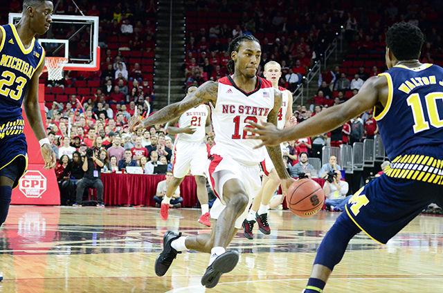 Junior Guard, Anthony "Cat" Barber, crosses up a Michigan defender on December 1st in PNC Arena. The Wolfpack suffered a 66-59 lost to the Michigan Wolverines. Barber scored 16 of the the Wolfpack's 66 points and shot one hundred precent from the free throw line.