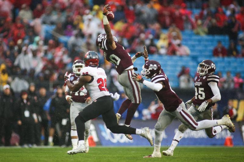 Redshirt freshman defensive back Brandon Bryant of Mississipe State intercepts Redshirt Senior quarterback Jacoby Brissett pass intended for Jaylen Samuels. Brissett threw 12 of 28 for 214 yards, one touchdown and two interceptions. The Wolfpack struggled on all sides of the ball losing 51-28 in the wind and rain inside the Bank of America Stadium in Charlotte, NC as part of the Belk Bowl on December 30th.