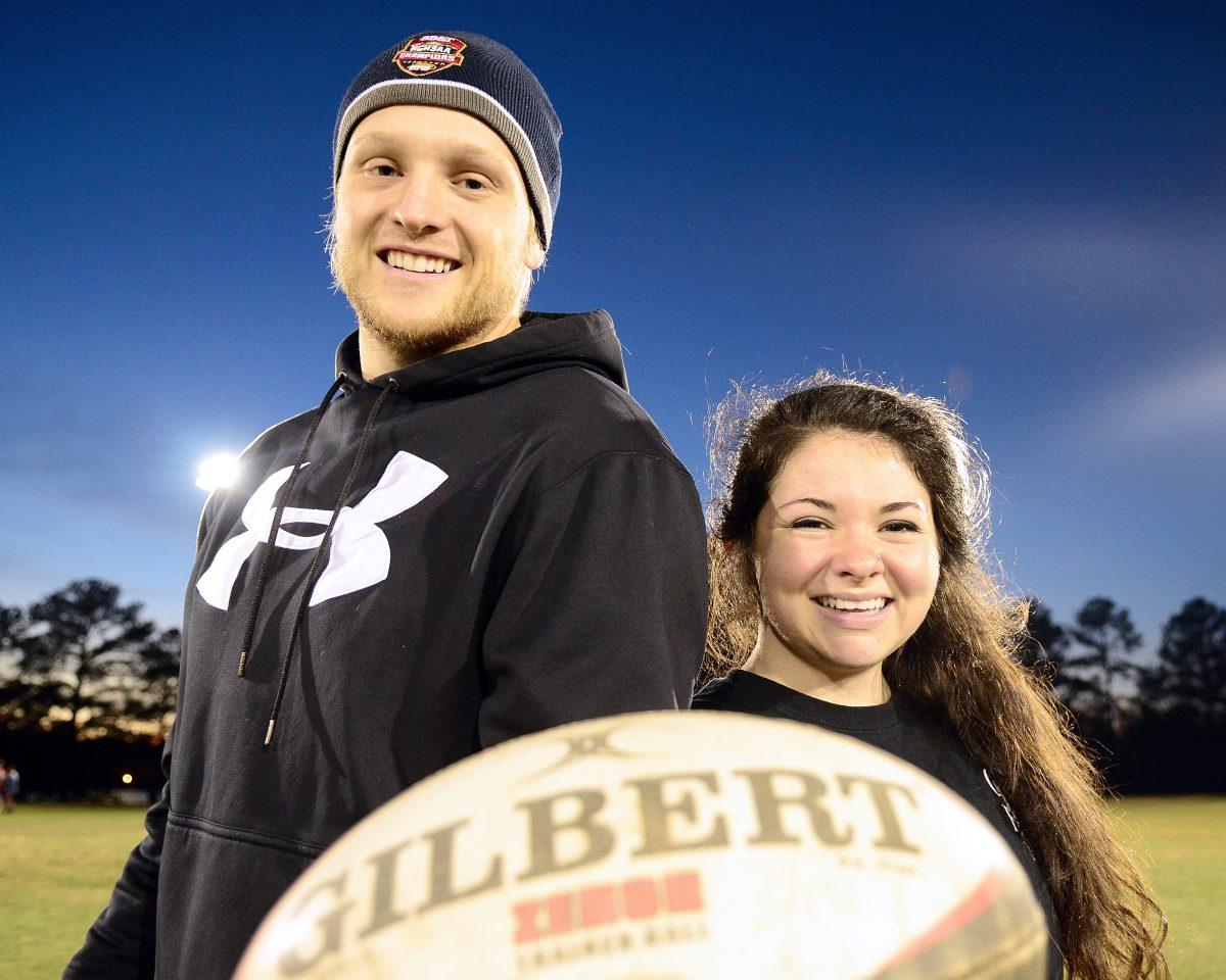 Stephen Glass, senior studying Nutrition Science and president of the men's rugby team, and Alanye McKnight, senior studying Environmental Science and president of the woman's rugby teams, pose for a portrait with a rugby ball on Method Field on Thursday, January 14, 2015.