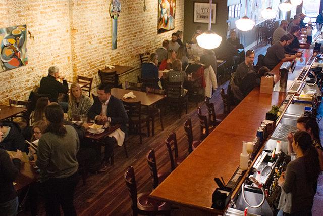 Customers dine at Busy Bee Cafe on Wilmington Street while chefs and other staff prepare a menu and food for Triangle Restaurant Week. This is the first year that Busy Bee will be participating in the event which features restaurants from all around Raleigh and the Triangle.
